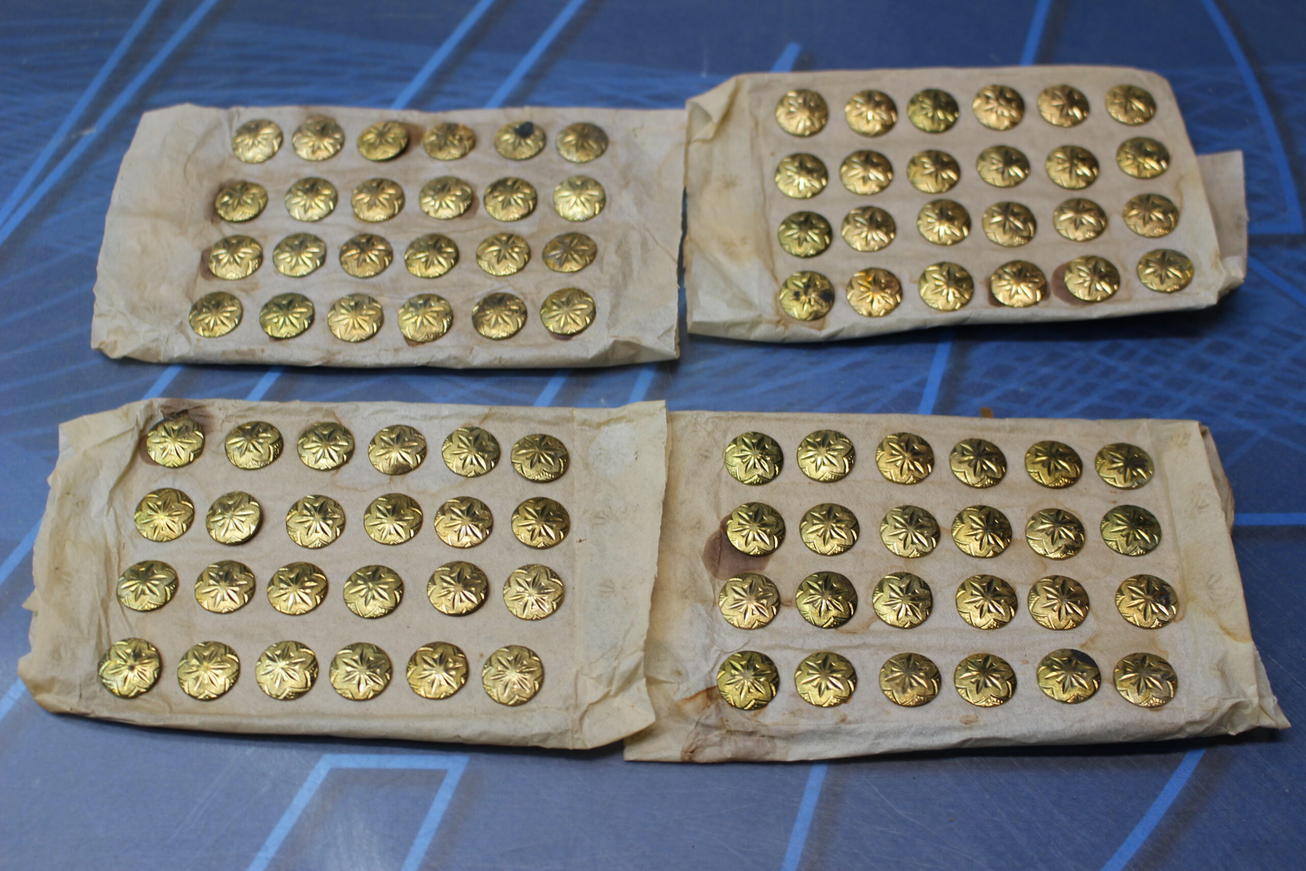 02. Antiguos botones metálicos dorados con estrella o flor en relieve.